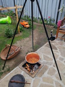 a pot of food is cooking over a fire at Apartman Lastovicka in Stará Lesná