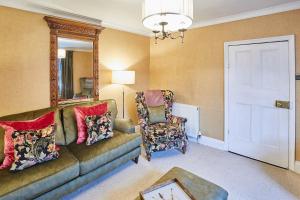a living room with a couch and a chair at Host & Stay - Sixpence Cottage in Pickering