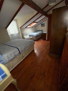 a bedroom with two beds in a attic at The Coach House By The Sea in Mablethorpe