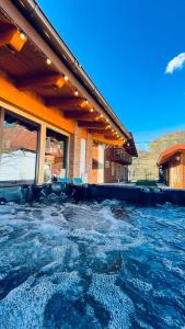 a pool of water in front of a house at Villa Diva in Budureasa