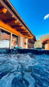 a pool of water in front of a house at Villa Diva in Budureasa +78 photos