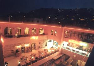 a large building with a restaurant in a city at night at Al Yasmeen Hotel in Nablus