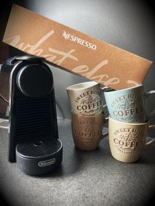 three coffee cups sitting next to a box at Alpenaquarium Grüblsee - FEWO Elfi in Vordernberg