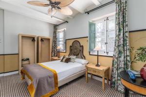 a bedroom with a bed and a window at Maison San Alfredo B&B in El Puig +80 photos