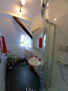 a bathroom with a sink and a shower at FeWo Weser in Hadamar +27 photos