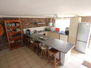 a kitchen with a large counter and a refrigerator at Clanwilliam Accommodation in Clanwilliam