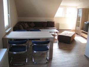 a living room with a table and chairs and a couch at Haus Beate Groß in Kröv