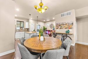 a dining room and kitchen with a wooden table and chairs at The Swoosh House in Beaverton