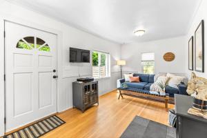 a living room with a blue couch and a door at The Cottage On Wilsonville Road in Wilsonville