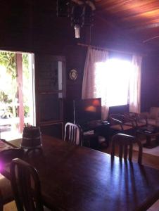 ein Esszimmer mit einem großen Holztisch und Stühlen in der Unterkunft Casa Riviera in Bertioga + 11 Fotos