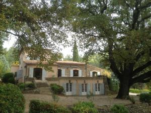 an old house with a tree in front of it at Bastide de Fave in Brue-Auriac +2 photos