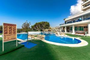 a resort with a swimming pool and a building at Sweet View Study - Playa Paraiso Tenerife in Adeje
