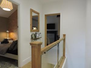 a stairway leading to a room with a bed at Bespoke Luxury Serviced Apartment in Macclesfield