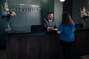a woman standing next to a man at a counter at The Fitzwilton Hotel in Waterford