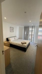 a bedroom with a bed and a large window at 3 bed apartment in London Plumstead in Woolwich