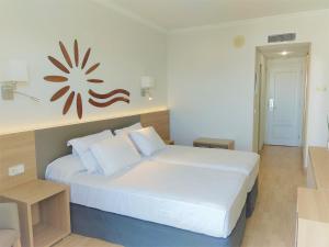 a bedroom with a large white bed in a room at Hotel Las Vegas in Salou
