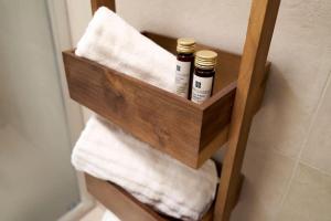a wooden shelf with towels in a bathroom at Residenza SubitoSanto - Appartamento 4A "Mantegna" in Padova