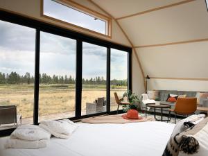 a room with a bed and a large window at Backland in Williams