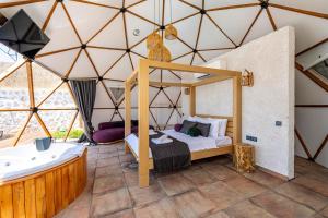 a room with a bed and a tub in a tent at Kalkan Dome Suites & Deluxe -Honeymoon Glamping in Kalkan-Antalya in Çayköy +36 photos