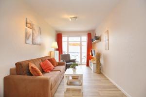 a living room with a couch and a table at Haffblick Wohnung 41 in Boltenhagen