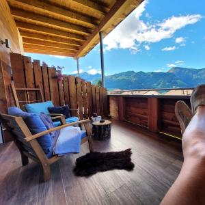 a person laying on a porch with a cat laying on the floor at Casa de Fiemme in Tesero