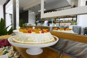 a cake with fruit on top of a counter at Best Western Hotel Martello in Lampedusa