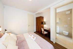 a bedroom with a bed and a bathroom with a desk at Villa Mihaela in Bled +56 photos