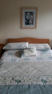 a bed with a quilt on it in a bedroom at 30 Quay Village Westport in Westport
