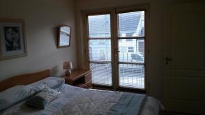a bedroom with a bed and a large window at 30 Quay Village Westport in Westport