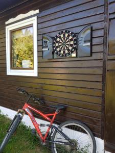 a bicycle parked next to a building with a dartboard at Pensiunea Daria Putna in Putna