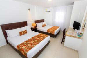 Postel nebo postele na pokoji v ubytování Hotel Playa Club