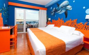 a bedroom with a bed with a shark on the wall at Diverhotel Aguadulce in Aguadulce