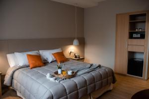 a bedroom with a bed with a basket on it at Gran Hotel Dakar in Mendoza
