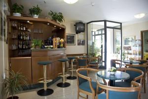 a bar with chairs and tables in a restaurant at Hotel Fortunella in Lido di Camaiore