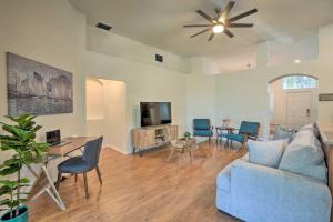 a living room with a blue couch and a tv at Sunny Brandon Getaway with Fire Pit! in Brandon