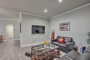 a living room with a couch and a tv at Aledo Home with Covered Patio and Spacious Yard! in Willow Park