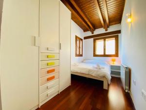 a bedroom with a bed and a dresser at Casa Forn in Pujal