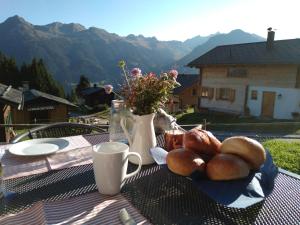 a table with a plate of bread and a cup of coffee at Alphüsli Garfrescha in Sankt Gallenkirch