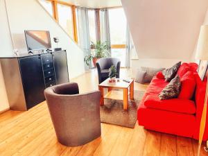 a living room with a red couch and a table at Elbinger Str. 28 in Hildesheim