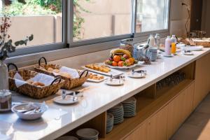 a breakfast buffet with food on a table at Gran Hotel Dakar in Mendoza