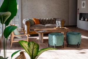 a living room with a couch and a table and chairs at Gran Hotel Dakar in Mendoza