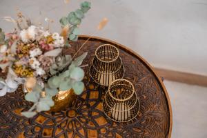 a wooden table with two nesting tables with flowers on it at Gran Hotel Dakar in Mendoza