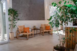 a room with chairs and a table and plants at Gran Hotel Dakar in Mendoza