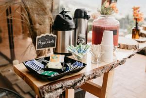 a table with plates and cups on top of it at Neusa Hills Eco Hotel Boutique in Tausa Viejo +12 photos