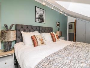 a bedroom with a large bed with white sheets and pillows at The Croft in Skipton +46 photos