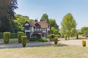 an old fashioned house with bushes in front of it at The Gate House by Bloom Stays in Folkestone