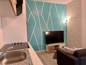 Televízia a/alebo spoločenská miestnosť v ubytovaní LE CLOS CHASSAING N1 - Wifi - Centre ville-PROPERTY RENTAL NM