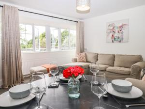 a living room with a table with wine glasses at Valley View in Teignmouth