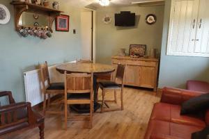 a living room with a table and chairs and a couch at 2 Bed Flat - Sleeps 4 - Patio - Parking - Wifi in Buxton