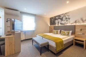 Postel nebo postele na pokoji v ubytování Hotel Rose